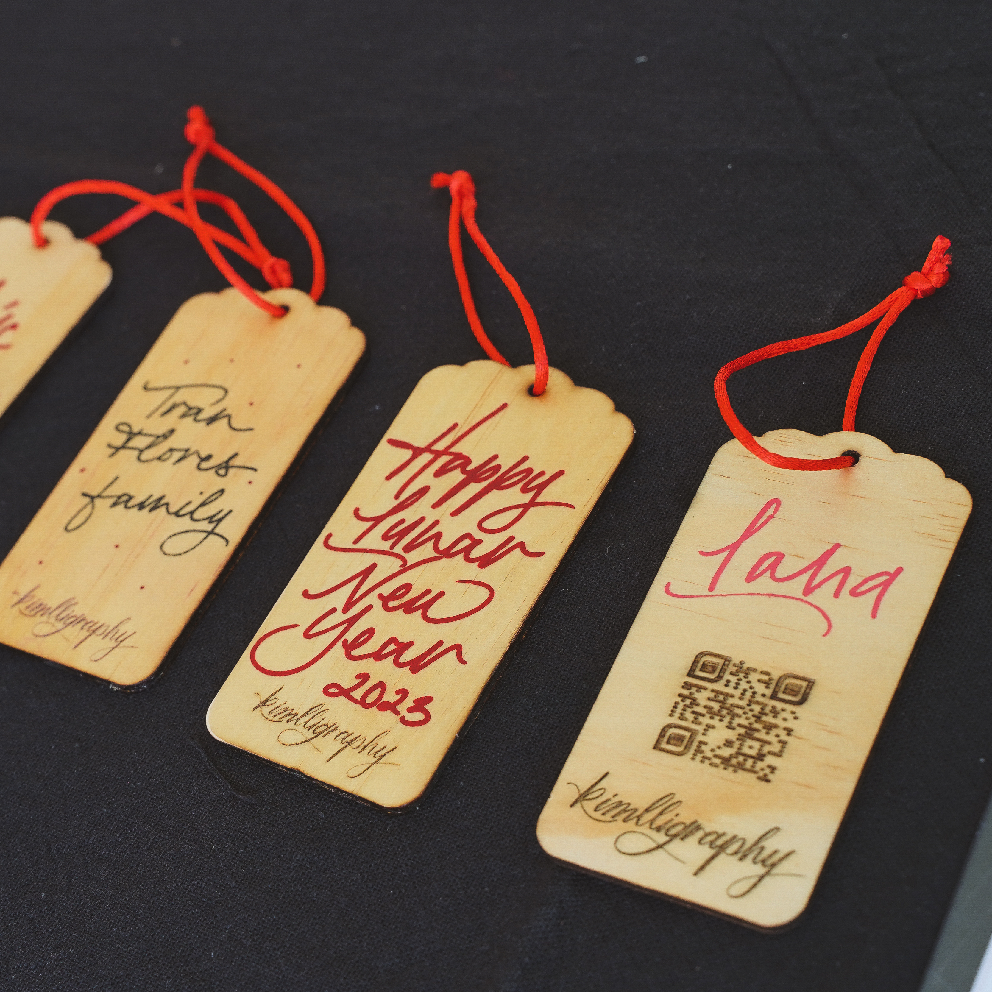 Handwritten calligraphy gift tags with red accents, perfect for festive events and celebrations.
